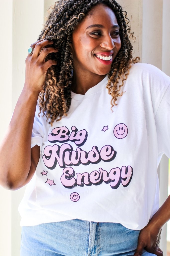 White tee with "Big Nurse Energy" in bubble letters in pink 