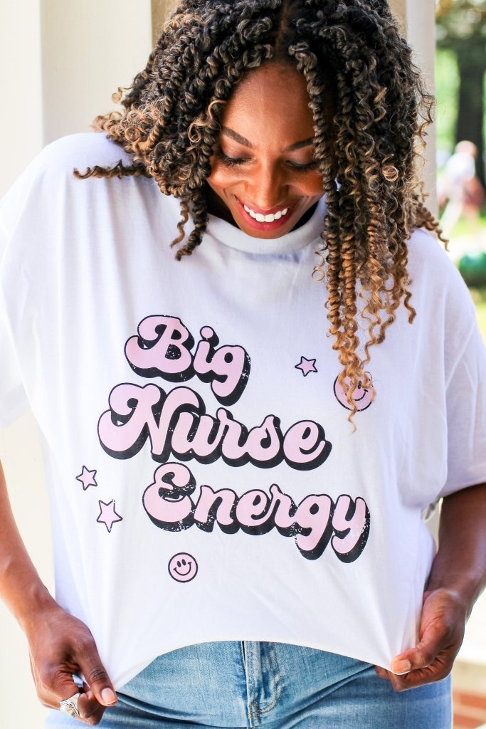 White tee with "Big Nurse Energy" in bubble letters in pink 