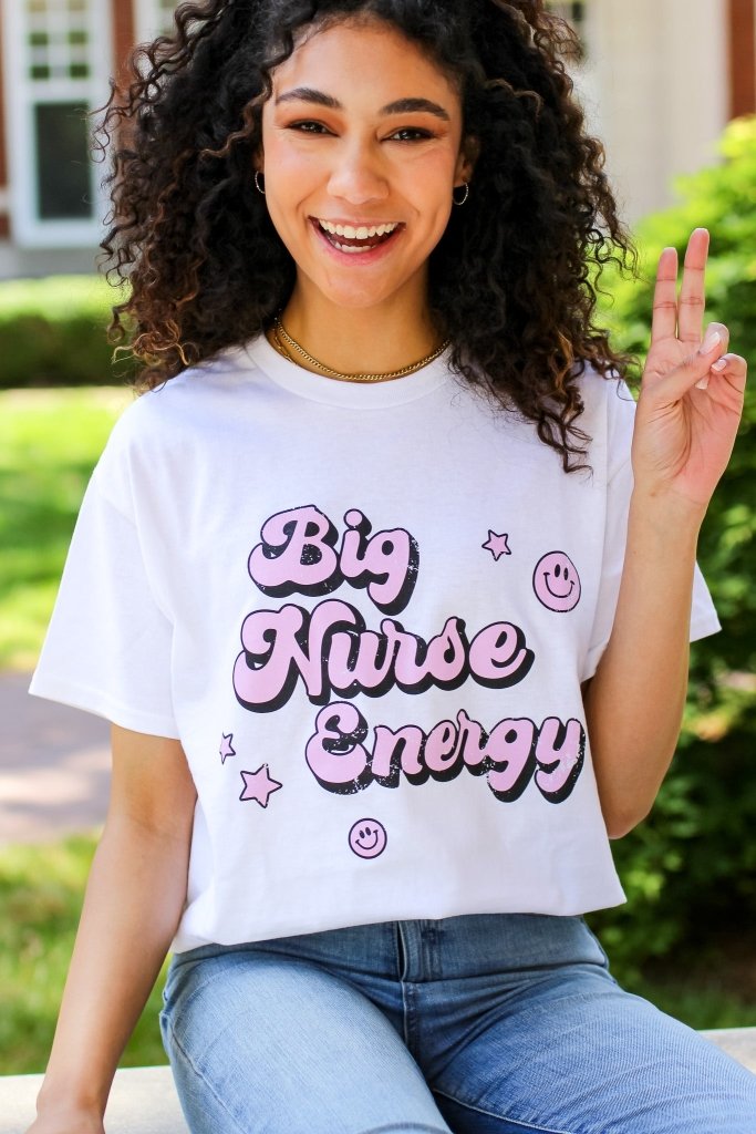 White tee with "Big Nurse Energy" in bubble letters in pink 