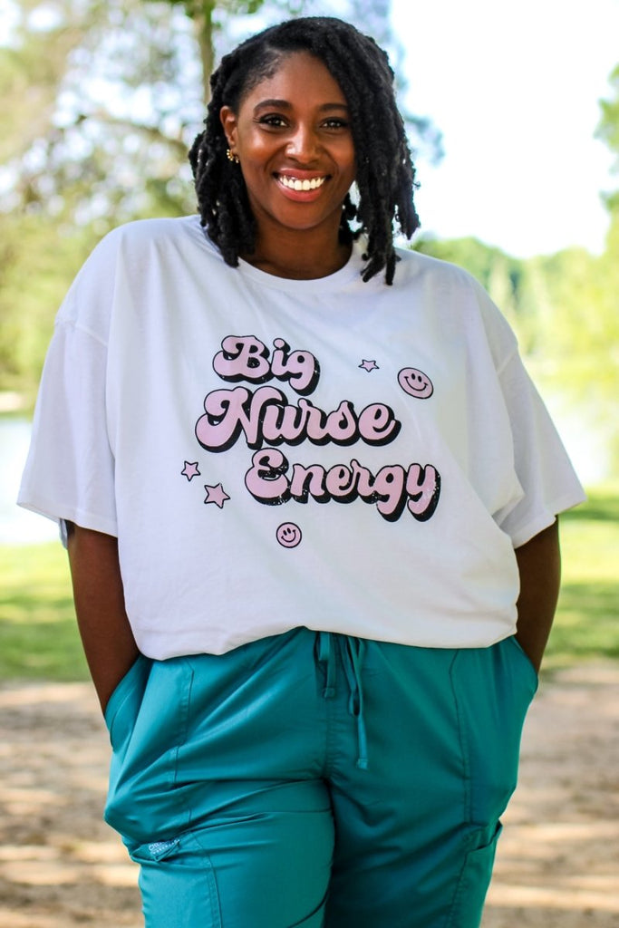 White tee with "Big Nurse Energy" in bubble letters in pink 