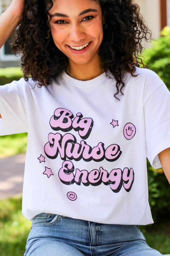 White tee with "Big Nurse Energy" in bubble letters in pink 