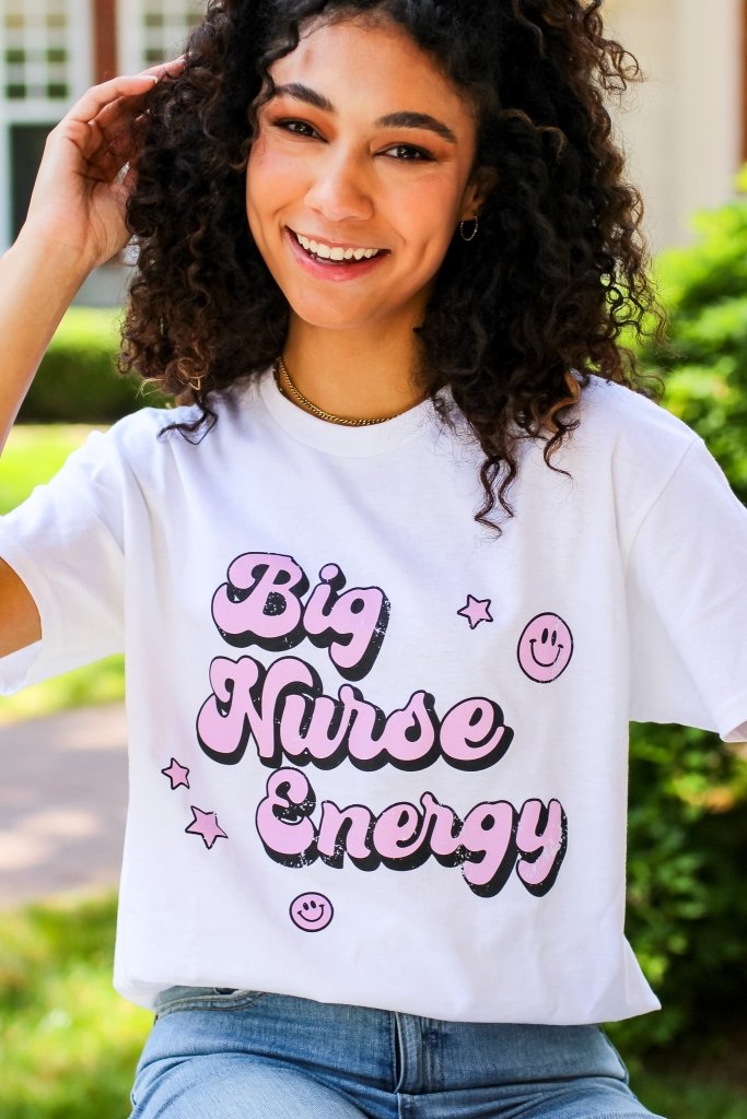 White tee with "Big Nurse Energy" in bubble letters in pink 