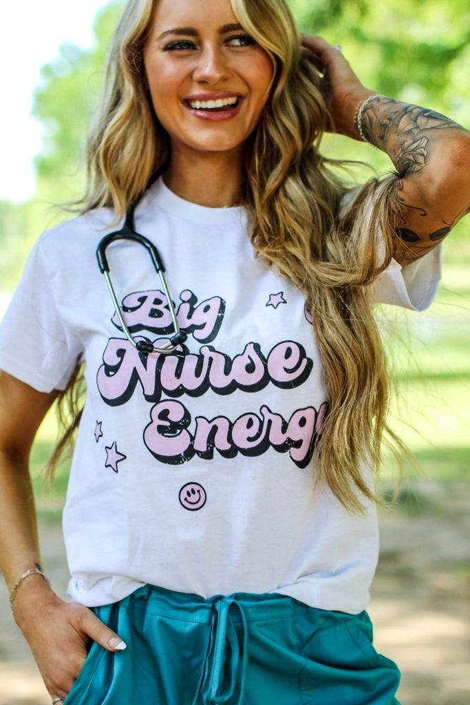 White tee with "Big Nurse Energy" in bubble letters in pink 